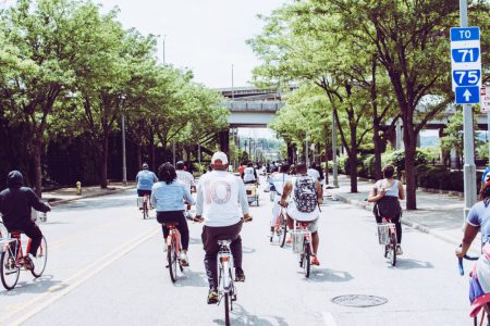 people riding bicycle on concrete road