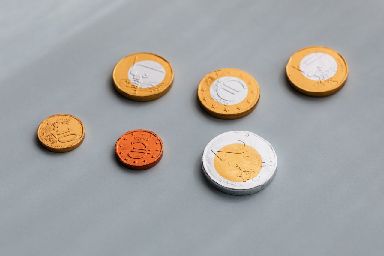 photo of chocolate coins on top of grey table