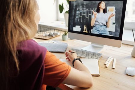 photo of girl watching through imac