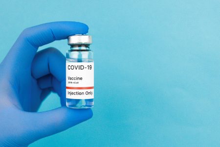 close up photo of a person holding covid vaccine