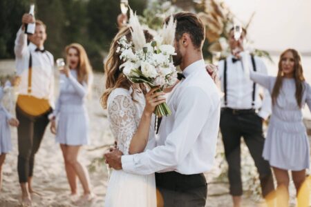 bride groom having their wedding with guests beach wp