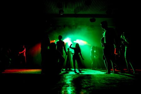 Dyskoteka na zakończenie wakacji silhouettes of people on the dancefloor in green light